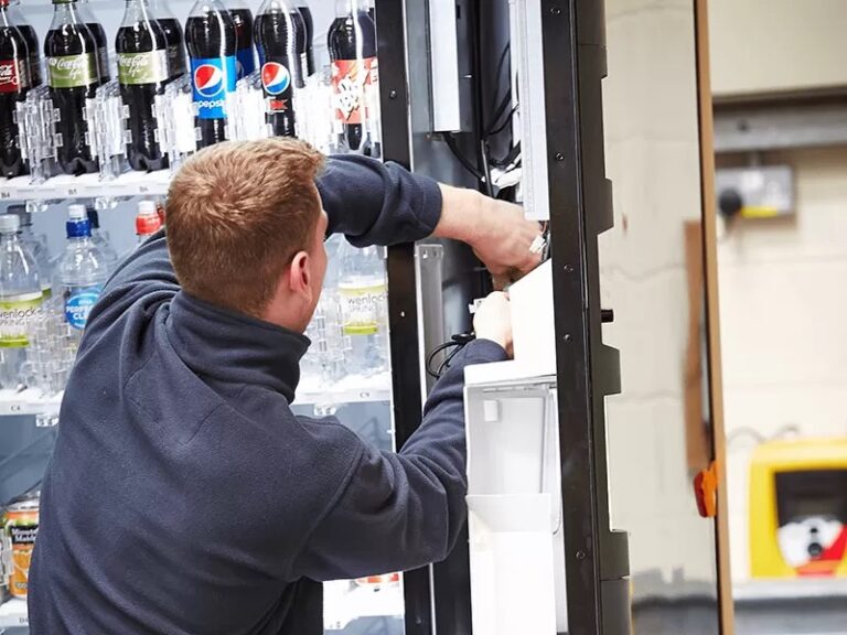 Technician performing vending machine service in Northview, Michigan for Nextline Vending